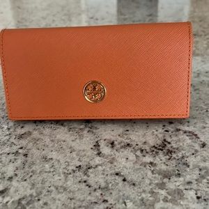 Tory Burch Sunglasses + Case with branding on each side of the glasses.